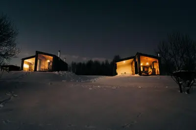 a couple of buildings in the snow at night at Stare Szałasy z widokiem na Tatry, sauna, jacuzzi, rowery in Klikuszowa