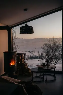 a room with a fireplace and a window with a view at Stare Szałasy z widokiem na Tatry, sauna, jacuzzi, rowery in Klikuszowa