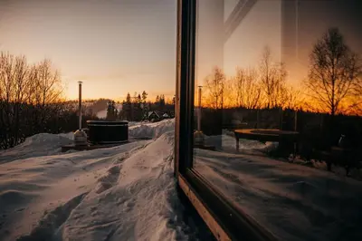 a view of a snow covered yard from a window at Stare Szałasy z widokiem na Tatry, sauna, jacuzzi, rowery in Klikuszowa