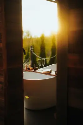 a table with two wine glasses and a window at Stare Szałasy z widokiem na Tatry, sauna, jacuzzi, rowery in Klikuszowa