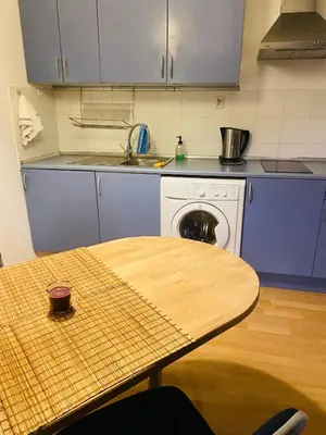 a kitchen with a table and a sink and a stove at Centrum Apart in Kraków