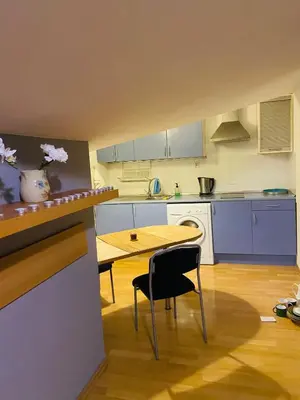 a kitchen with a table and a table and chairs at Centrum Apart in Kraków