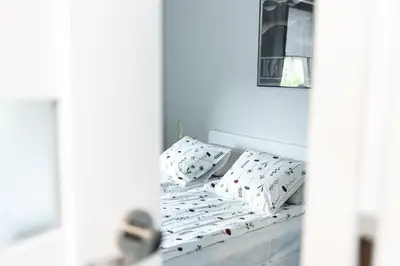 a bed with pillows on it in a room at Modern House in Old Town Numero 8 in Kraków