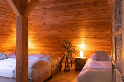 a bedroom with two beds in a wooden room at BlissHouse Luxurious Guesthouse calm and energetic spot near by city surrounded by the forest where you will find your peace and your people in Kraków