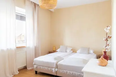 a bedroom with two beds and a window at BlissHouse Luxurious Guesthouse calm and energetic spot near by city surrounded by the forest where you will find your peace and your people in Kraków