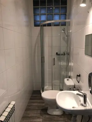 a bathroom with a shower and a toilet and a sink at Szczebel in Kraków