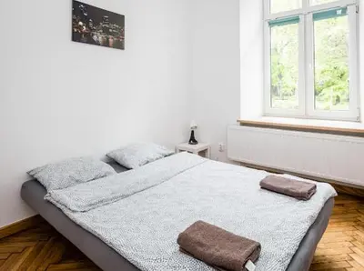 a bedroom with a bed with two towels on it at Szczebel in Kraków
