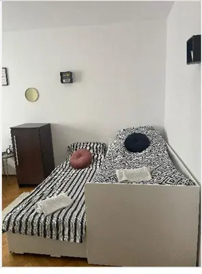 a desk with a black chair in front of a table at Cheerful 3 bedroom city house in Kraków
