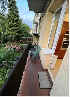 a bedroom with a bed in a room with a window at Cheerful 3 bedroom city house in Kraków