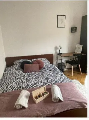 a bedroom with two beds and a wooden floor at Cheerful 3 bedroom city house in Kraków