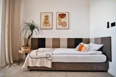 a bedroom with a bed with three pictures on the wall at Apartament Nairobi by Housine in Zator