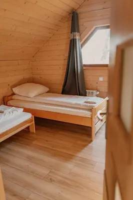a small room with a bed and a window at Apartament Sosnowy Domek Piętro Zator Graboszyce in Graboszyce
