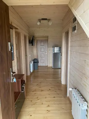 a hallway in a house with a refrigerator at Apartament Sosnowy Domek Piętro Zator Graboszyce in Graboszyce