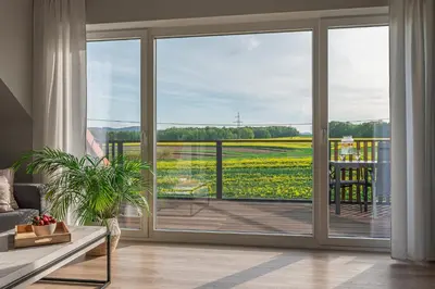 a living room with a sliding glass door with a view at Lamelove Apartments - Energylandia, Zator in Chocznia