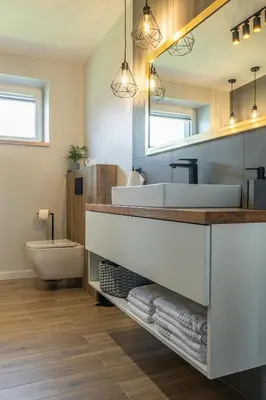 a bathroom with a sink and a toilet and a mirror at Lamelove Apartments - Energylandia, Zator in Chocznia