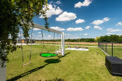 a swing set in a yard with a field at Lamelove Apartments - Energylandia, Zator in Chocznia