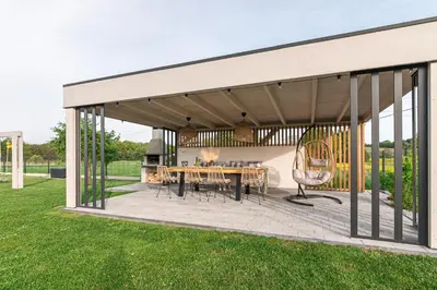 a pavilion with a table and chairs on a patio at Lamelove Apartments - Energylandia, Zator in Chocznia