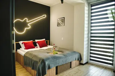 a bedroom with a bed with a sign on the wall at Blues Room by Housine in Zator