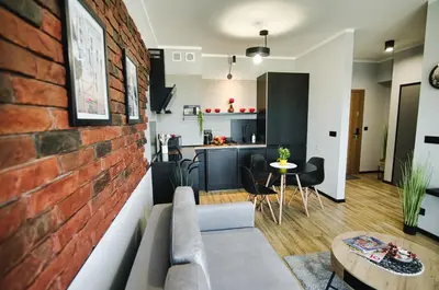 a living room and kitchen with a brick wall at Blues Room by Housine in Zator