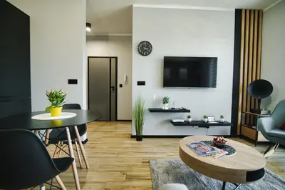 a living room with a table and chairs and a tv at Blues Room by Housine in Zator