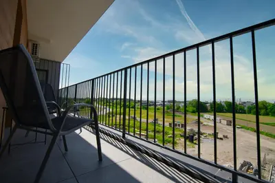 a balcony with a chair and a view of a field at Blues Room by Housine in Zator