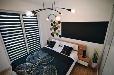 a bedroom with a bed and a large window at ApartHome 25 by Housine in Zator