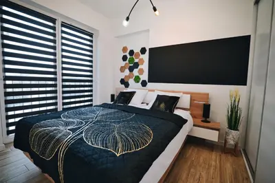 a bedroom with a large bed and a flat screen tv at ApartHome 25 by Housine in Zator