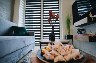 a plate of food on a table in a living room at ApartHome 25 by Housine in Zator