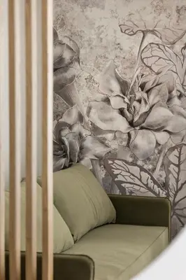 a bedroom with a crib with a flower wallpaper at Artis Apartments by Housine in Zator