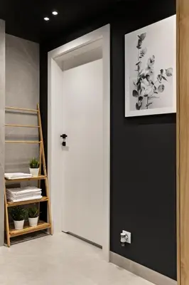 a white door in a room with a black wall at Artis Apartments by Housine in Zator