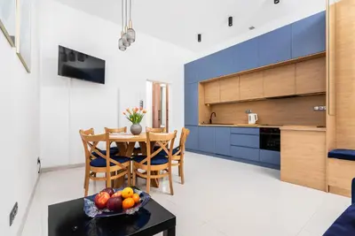 a kitchen and dining room with a table and chairs at Premium Splendid Old Town Suites - by Upstairs in Kraków