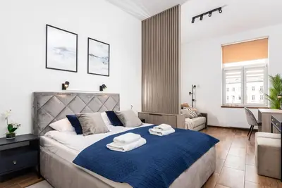a bedroom with a large bed with towels on it at Premium Splendid Old Town Suites - by Upstairs in Kraków