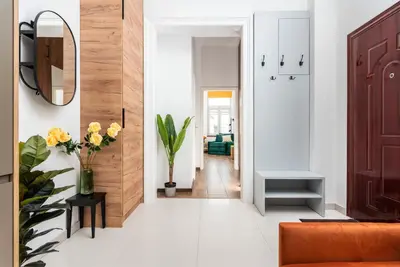a corridor of a living room with an orange couch at Premium Splendid Old Town Suites - by Upstairs in Kraków