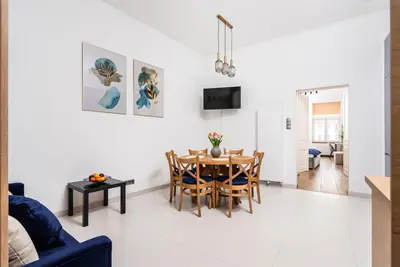a dining room and living room with a table and chairs at Premium Splendid Old Town Suites - by Upstairs in Kraków