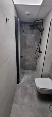 a bathroom with a shower and a toilet at Apartament Xavier Kraków in Kraków
