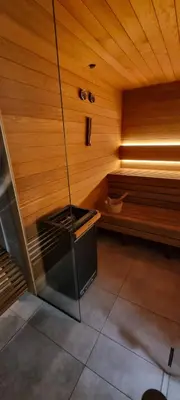 a room with a sauna with a bench and a tub at Apartament Xavier Kraków in Kraków