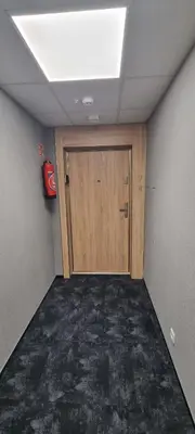 an empty room with a door and a fire extinguisher at Apartament Xavier Kraków in Kraków