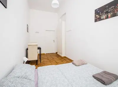 a white room with two beds and a desk at CASIO in Kraków