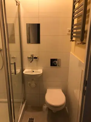 a small bathroom with a toilet and a sink at CASIO in Kraków