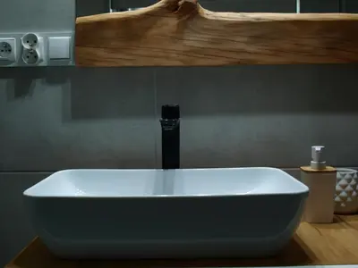 a white sink with a faucet in a bathroom at Panorama Racławicka Domek Willa Basen Agroturystyka in Janowiczki