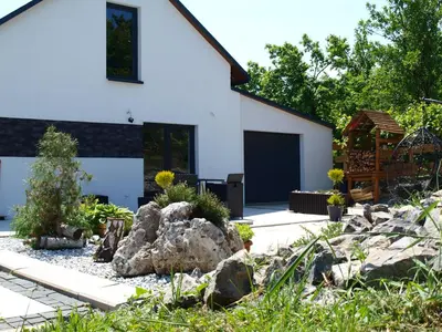 a garden in front of a house at Panorama Racławicka Domek Willa Basen Agroturystyka in Janowiczki