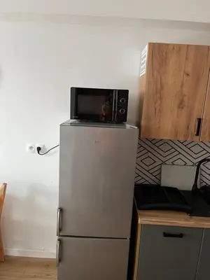 a microwave on top of a refrigerator in a kitchen at Apartament Marko Due in Zator