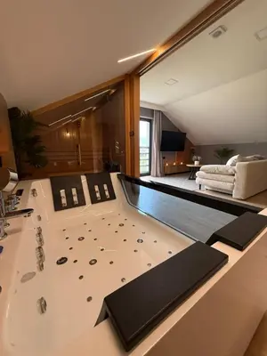 a jacuzzi tub in the middle of a room at Secret House Zator in Zator