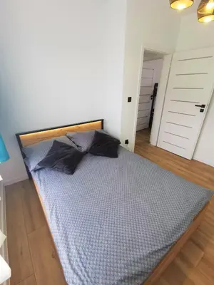 a bedroom with a large bed in a room at Secret House Zator in Zator
