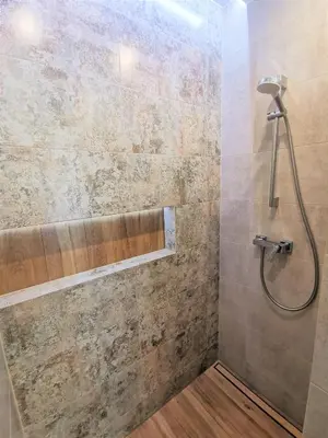 a shower with a shower head in a bathroom at Secret House Zator in Zator