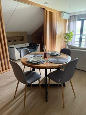 a dining room table and chairs in a kitchen at Secret House Zator in Zator