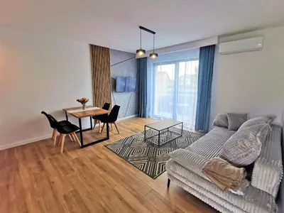a living room with a couch and a table at Secret House Zator in Zator