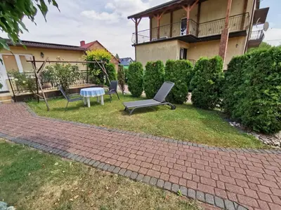 a patio with a bench and a table in a yard at Agrostrzecha in Ryczów