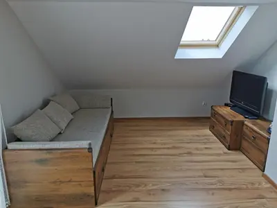 a living room with a couch and a tv at Agrostrzecha in Ryczów