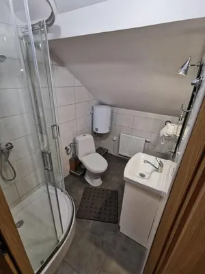 a bathroom with a shower and a toilet and a sink at Agrostrzecha in Ryczów